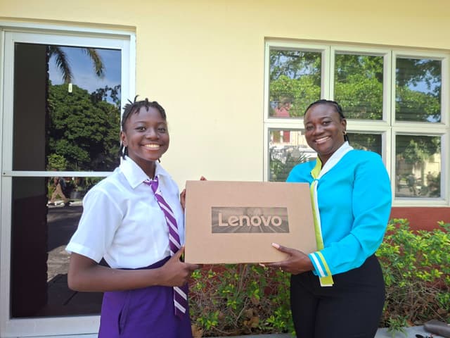 Azaylia Palmer with her teacher holding her new Lenovo laptop